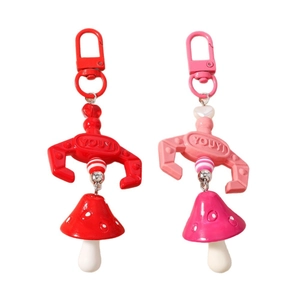 Red and pink beaded mushroom keychains with lobster clasps and striped decorative charms