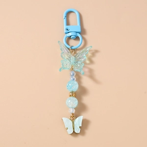 Detail of blue beaded butterfly keychain featuring translucent charms and lobster clasp