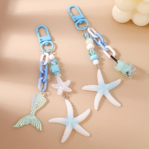 Marine theme beaded keychain featuring blue starfish, mermaid tail, and milk tea charms