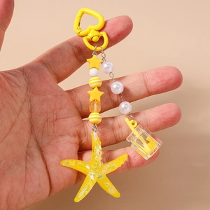 Detailed view of ocean style beaded keychain with yellow starfish and miniature bottle