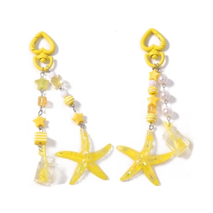 Star beaded keychain with yellow starfish and soda bottle pendant on white background