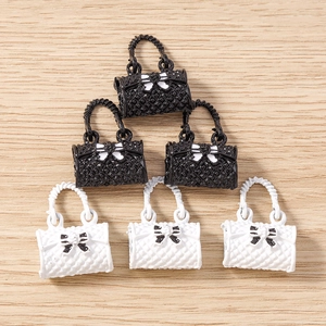 Macro shot of 6 mini quilted handbag charms in black and white for DIY jewelry making