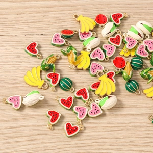 Detail of colorful enamel fruit charms including banana and watermelon for DIY jewelry making