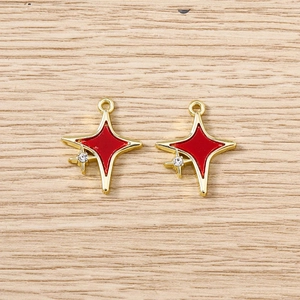 Détail de pendentifs étoile dorée avec émail rouge et accents de cristal brillant
