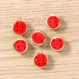 Macro detail of watermelon-shaped alloy pendants for DIY jewelry and keychain making