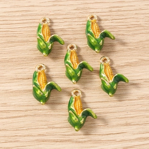 Detailed view of six yellow corn charms with green leaves for DIY jewelry making
