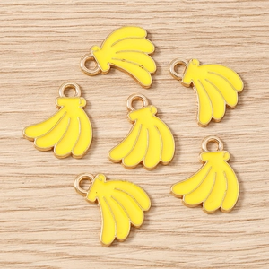 Detailed macro view of yellow enamel banana charms with gold plating for jewelry making