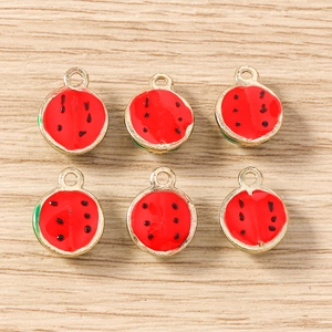 Detail view of red enamel watermelon charms with gold edges for DIY jewelry making