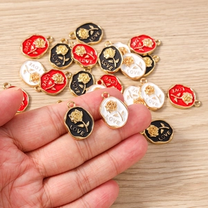 Detail of rose alloy charms with LOVE engraving for jewelry making in multiple colors
