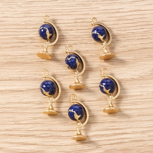 Detailed view of six blue enamel globe charms for DIY jewelry making on wood background