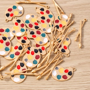 Vue détaillée de breloques palette d'artiste et pinceaux pour création de bijoux DIY
