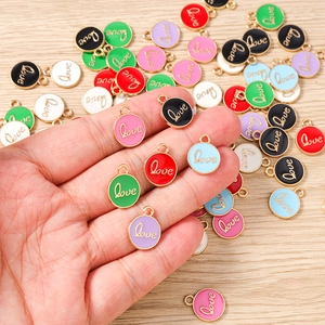 Detail showing colorful enamel Love charms with gold trim for DIY jewelry making