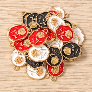 Macro detail of enamel rose flower charms with LOVE lettering for DIY jewelry making