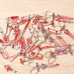 Gothic horror tool charms with blood splatters for Halloween jewelry making