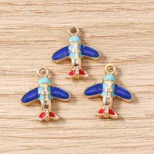 Detailed macro view of colorful enamel airplane charms for DIY jewelry making accessories