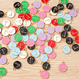 Detailed close-up of colorful enamel love charms with gold plating for DIY jewelry making