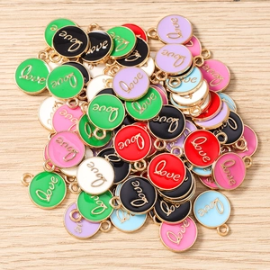 Macro view of colorful round enamel Love pendants for DIY jewelry and keychain making