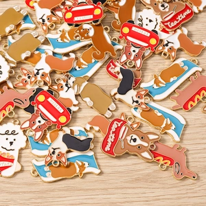 Detail of assorted dog charms featuring corgi and poodle designs with enamel finish