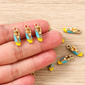 Macro detail of blue and yellow enamel sneaker charms for DIY jewelry crafting