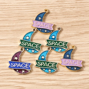 Detailed macro view of enamel space-themed moon charms with stars and Space lettering