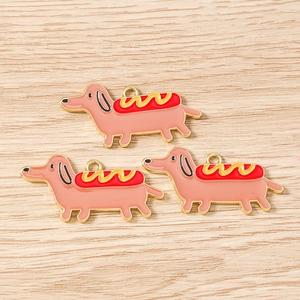 Detail of cute dachshund hot dog enamel charms with gold edges for DIY jewelry making