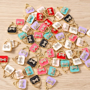 Macro shot of assorted colorful handbag charms with rhinestone bows for DIY jewelry