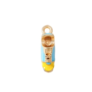 Mini sneaker charm for jewelry making in blue and yellow alloy with a golden metallic finish
