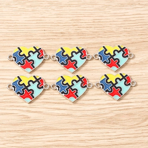 Detail of colorful puzzle heart charms with enamel inlay for DIY jewelry connectors