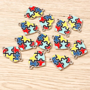 Macro shot of colorful puzzle heart charms for autism awareness DIY jewelry making