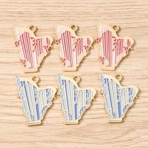 Detail of harp shaped alloy pendants with colorful enamel and gold edges for jewelry making