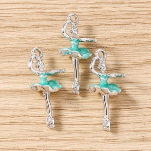 Detail of three mint green enamel ballet girl charms for DIY jewelry making