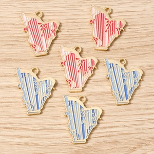 Detailed macro view of enamel harp charms with gold plating for DIY jewelry making