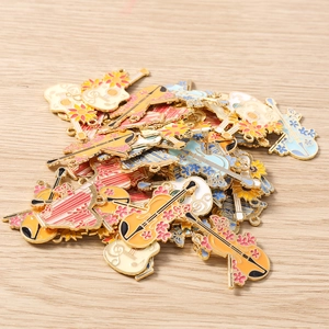 Macro detail of colorful enamel musical instrument charms for DIY jewelry making