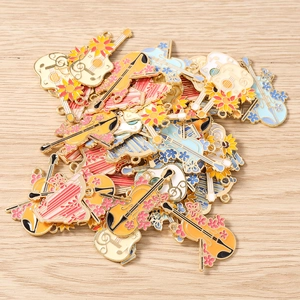 Detail of colorful instrument charms with floral patterns and gold-plated finish