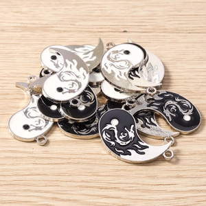 Macro detail of yin yang dragon charms with enamel finish for DIY jewelry making