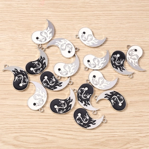 Detail of dragon-patterned Yin Yang pendants with enamel finish for DIY jewelry crafts