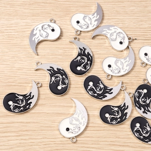 Detailed view of alloy Yin Yang dragon pendants with black and white enamel finish