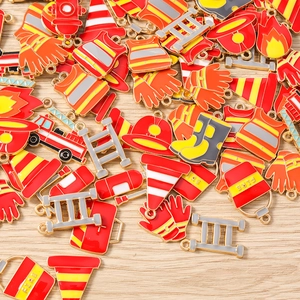 Detailed close-up of colorful enamel fire safety charms with vibrant red fire trucks and gear