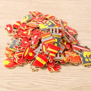 Macro shot of assorted red enamel fire fighter charms with gold plating for DIY jewelry