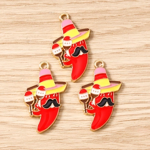 Detail view of Mexican chili enamel charms with sombreros and maracas for DIY jewelry
