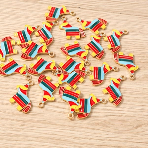 Macro shot of colorful striped llama enamel charms with gold metal edges for DIY jewelry
