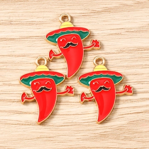 Macro detail of three enamel chili pendants with sombreros for DIY jewelry making