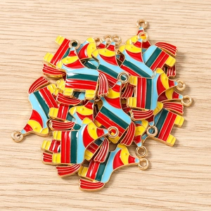 Close-up of colorful donkey pinata charms with gold plating and striped enamel details