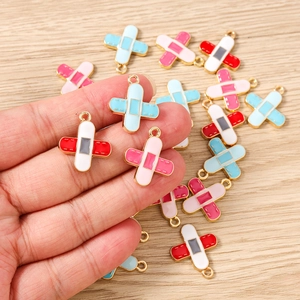 Macro view of colorful enamel band-aid charms for DIY jewelry making and crafts