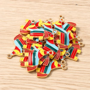 Macro detail of colorful enamel horse pendants with gold alloy loops on wood