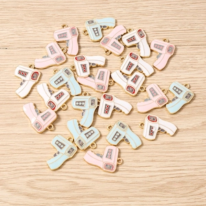 Close-up of thermometer charms in pink, blue and white for DIY jewelry making