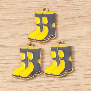 Detailed macro view of yellow enamel rain boot pendants with gold-plated alloy rings