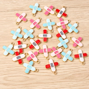 Detail of colorful band-aid shaped enamel charms with gold plating for DIY jewelry making