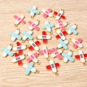 Close-up of bandage charms in blue and pink with gold edges for DIY jewelry making