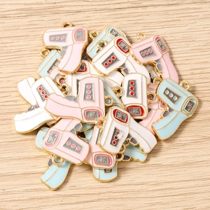 Macro detail of thermometer-shaped enamel pendants with gold edges and 36.6 display